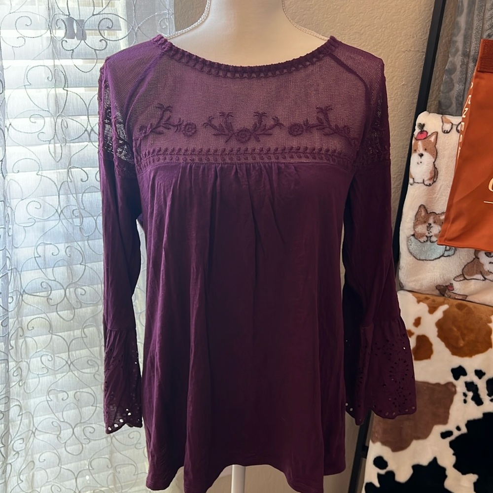 Ladies 3/4 bell sleeve shirt. Lace detail at sleeves and top. Berry/maroon color